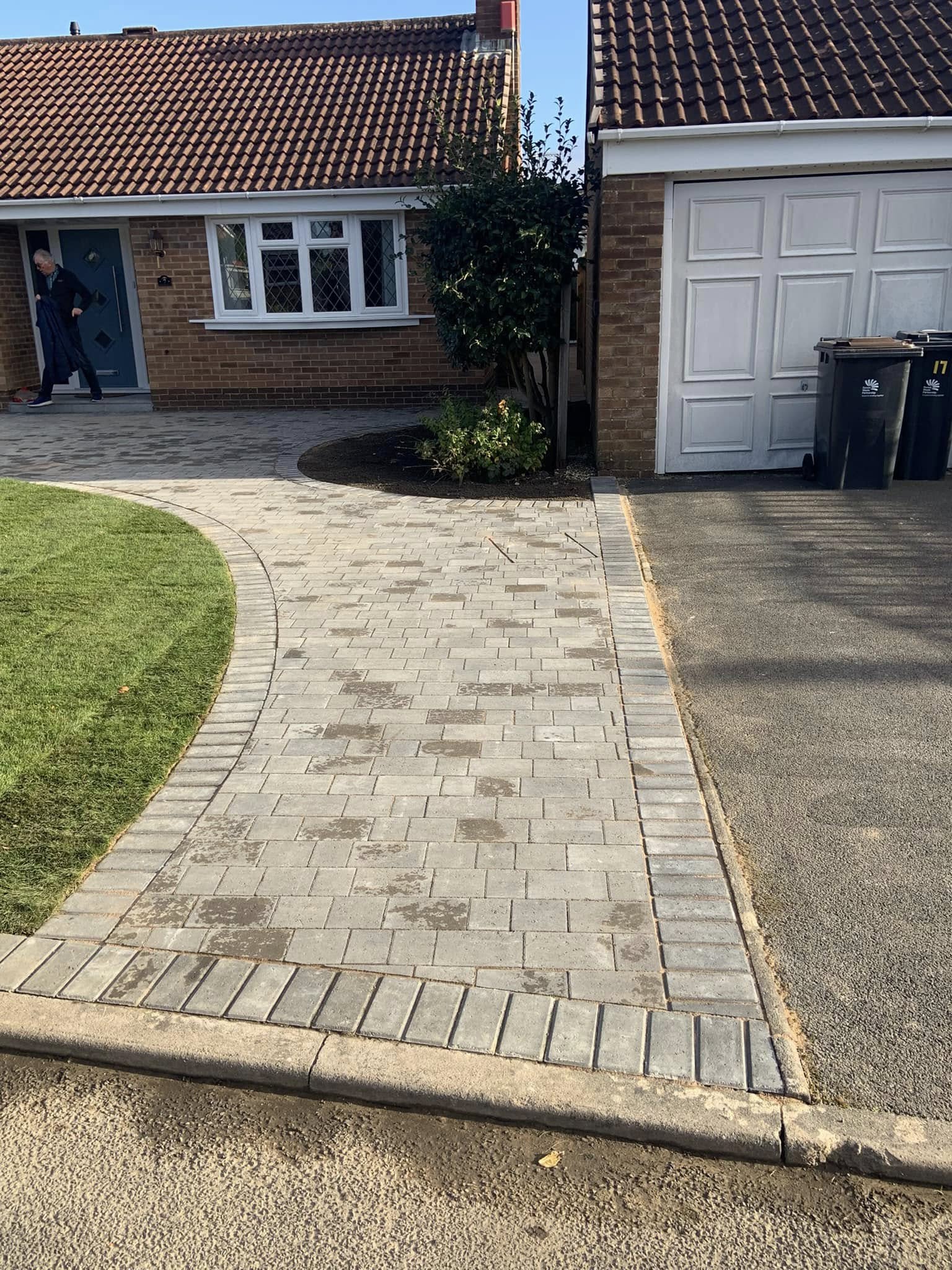 Curved block paved pathway leading to front entrance
