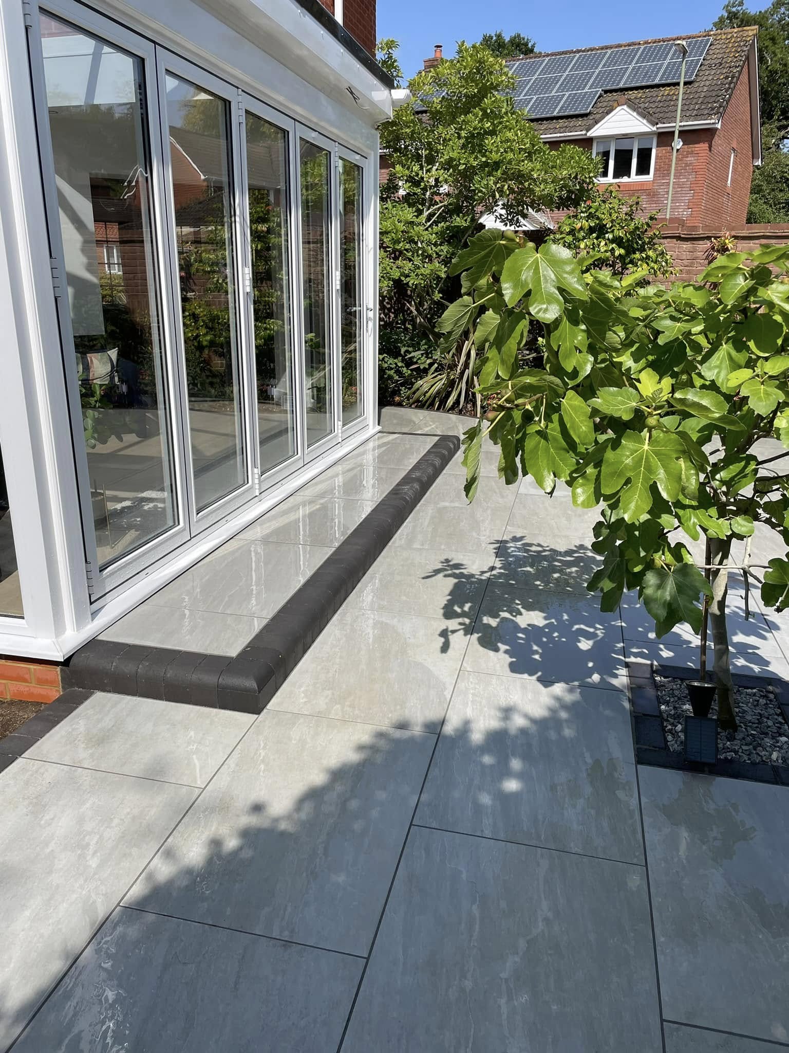 Custom block paving patio with custom flower beds and lighting