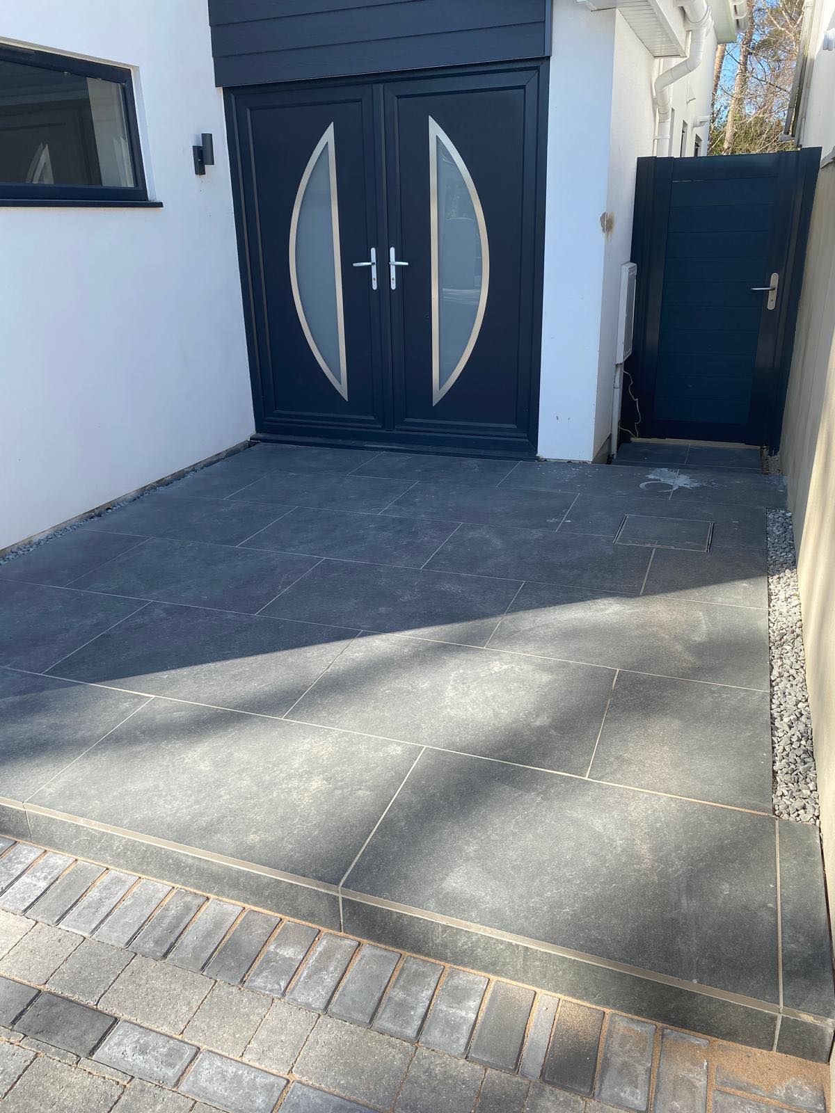 Combination of paving and tiles leading to entrance of home in Hampshire