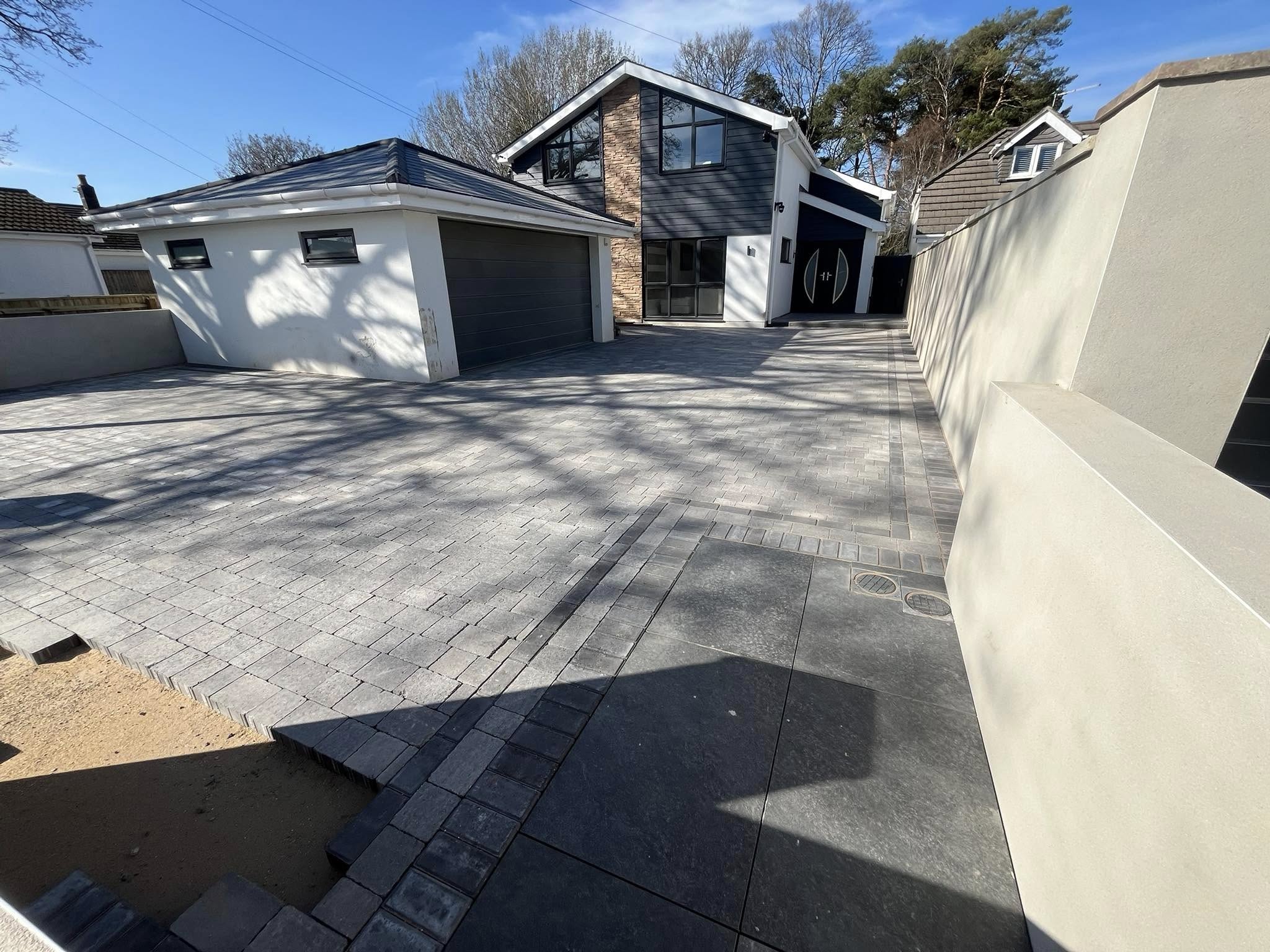 Large driveway with mixed paving patterns in Dorset